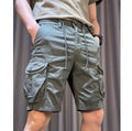 A model wearing loose straight-leg multi-pocket overalls in a khaki colour.