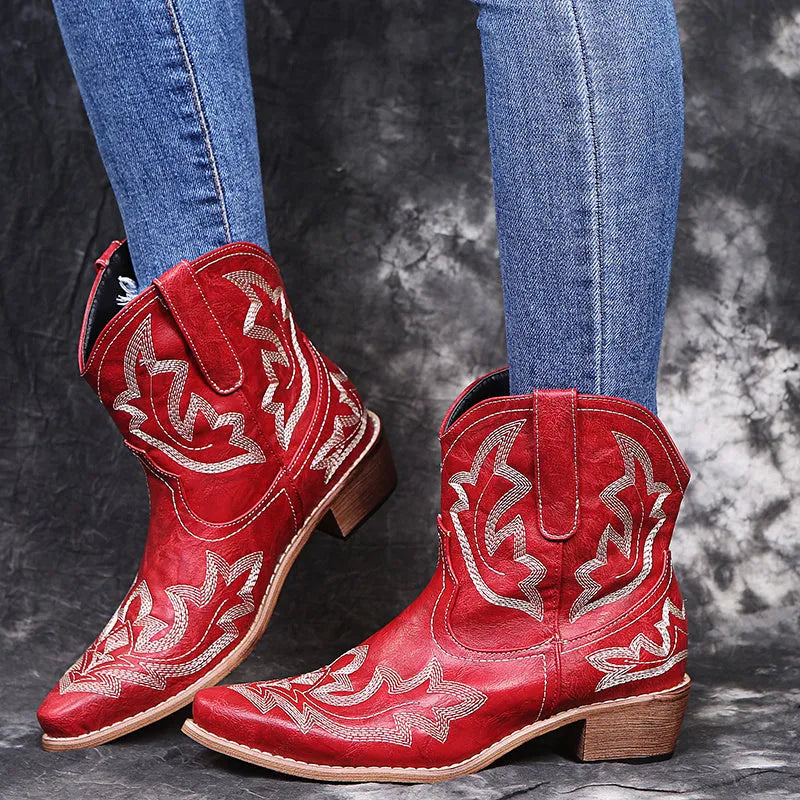 Blue women's cowboy boots with white embroidery, a low wedge heel, and a pointed toe