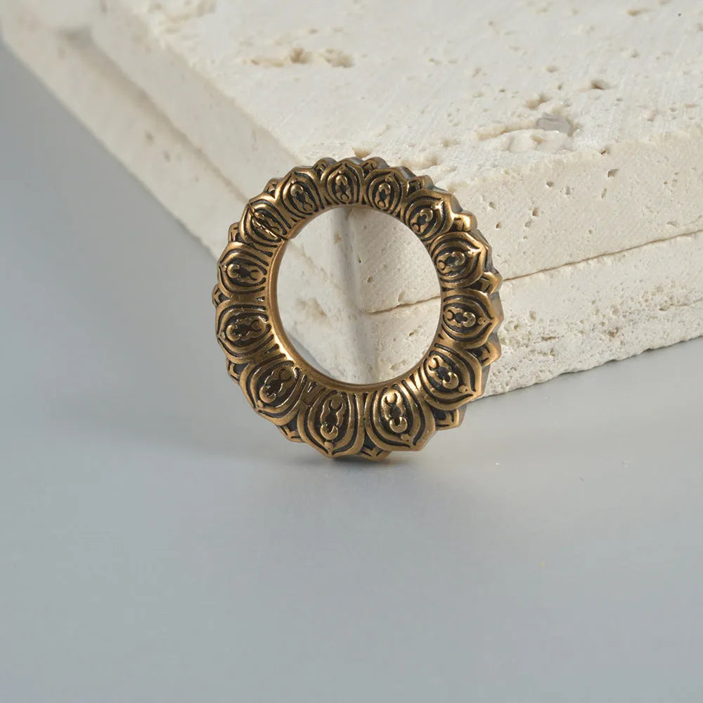 Retro heart-shaped hollow lotus magnetic earrings in stainless steel with antique finishes