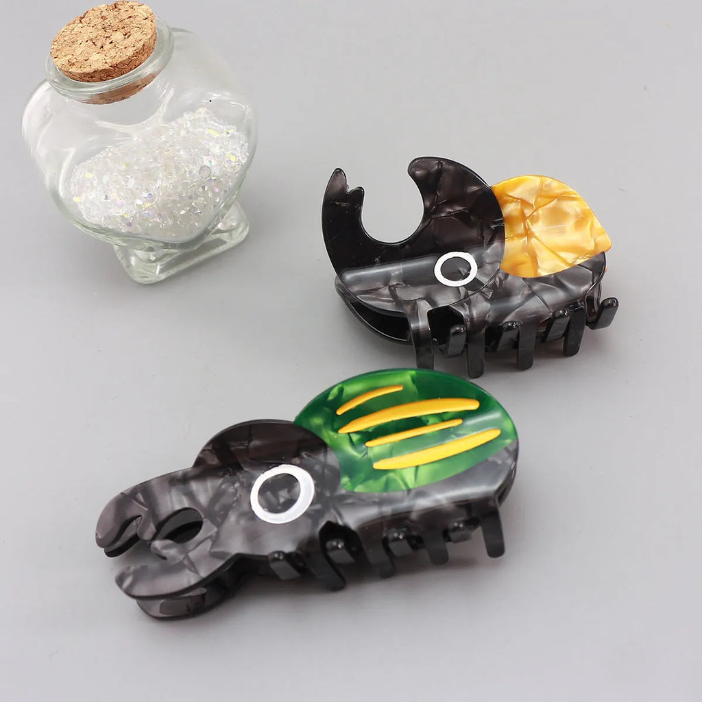 Cellulose acetate sheet Beetle Grip decorative art showing cartoon insect designs in green, orange or white.