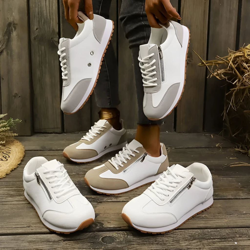 Women's flat-heeled shoes in artificial PU, available in Champagne, Gray, and White colours with a rubber sole.