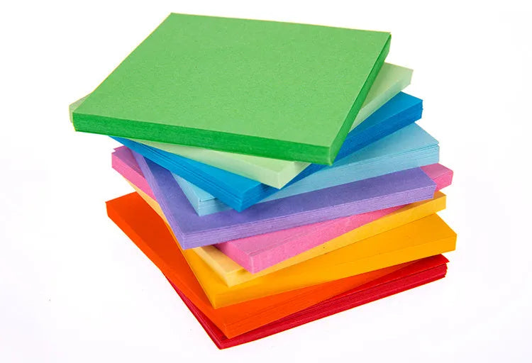 Assortment of colourful mini paper scrolls with metal eyelets in various sizes.