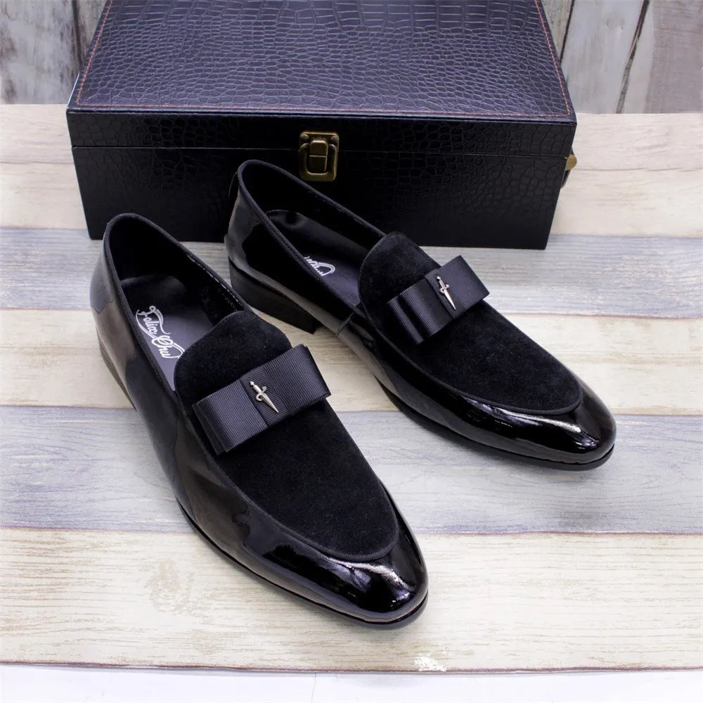 Men's black patent leather low-top dress shoes with a tassel detail on the front.