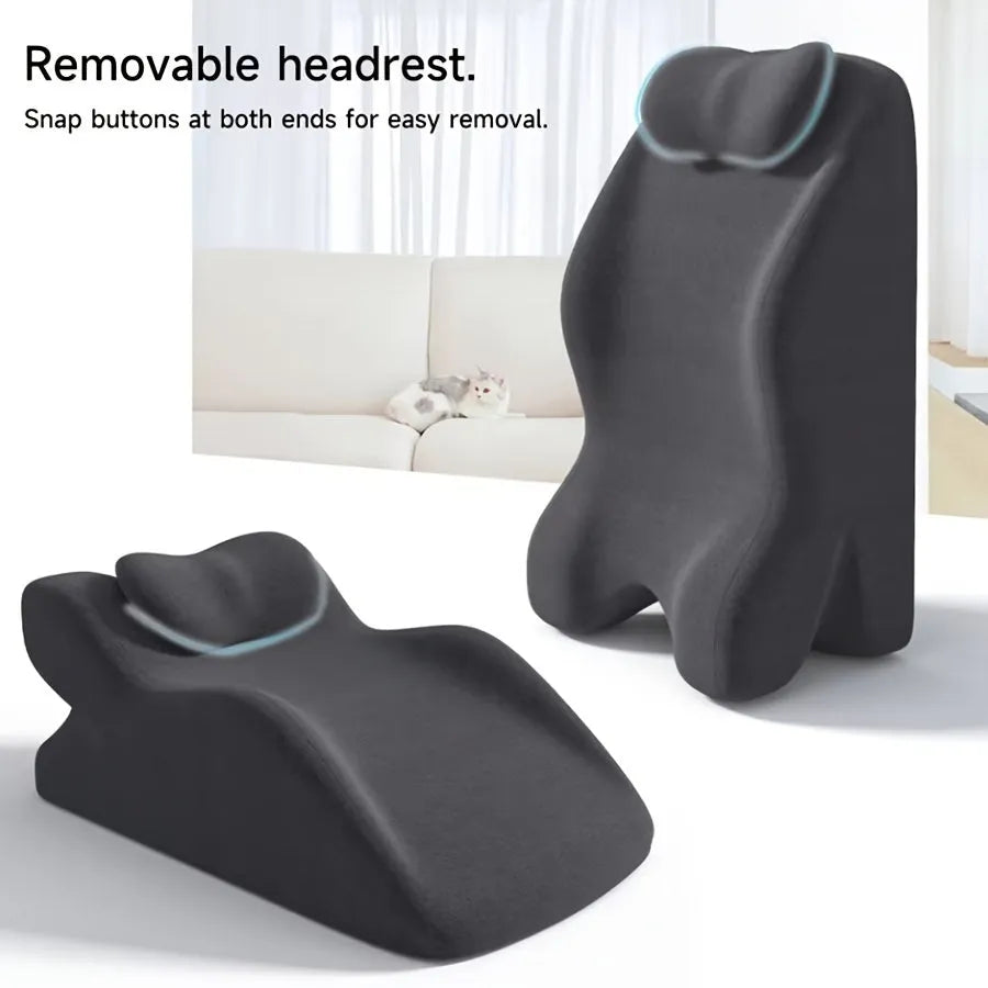 A stomach sleeper pillow shown in light grey, designed for reading or phone use in a prone position.