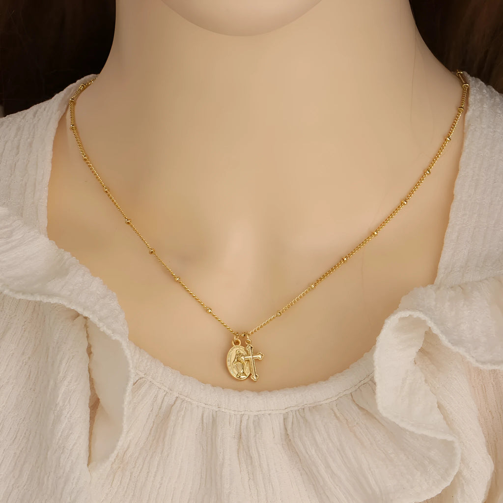 Gold Virgin Mary necklace with geometric cross pendant on copper chain