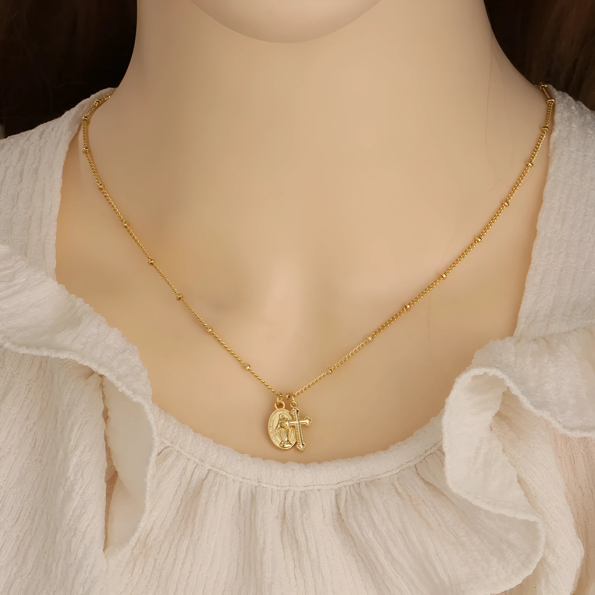 Gold Virgin Mary necklace with geometric cross pendant on copper chain
