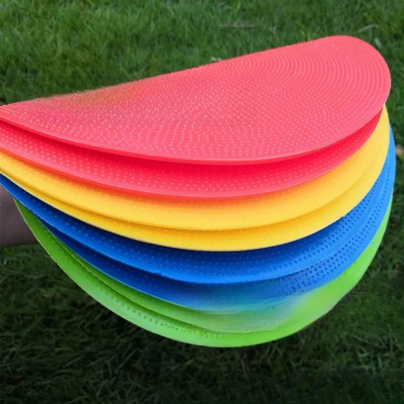 Soft yellow TPE football training landmark pad on grass, showing 23cm diameter.
