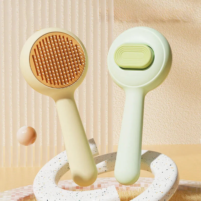 Green and yellow cat grooming brush with stainless steel comb teeth and a non-slip handle.