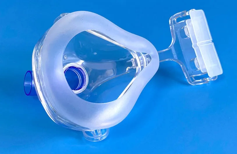 Transparent CPAP breathing mask with silicone cushion, headgear and two rotary elbows for ventilator connection