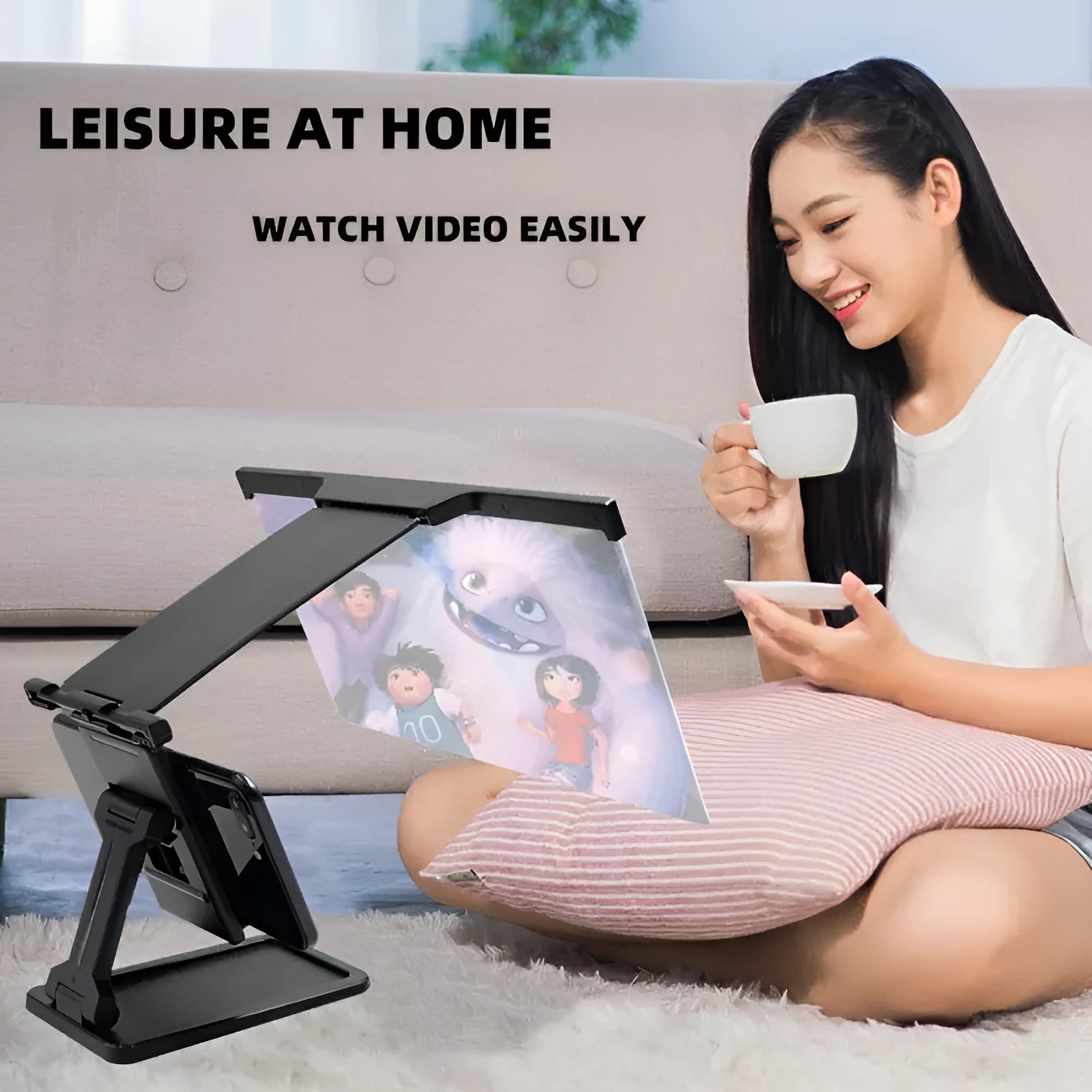 Black foldable mobile phone screen magnifier with detachable phone holder on a desk