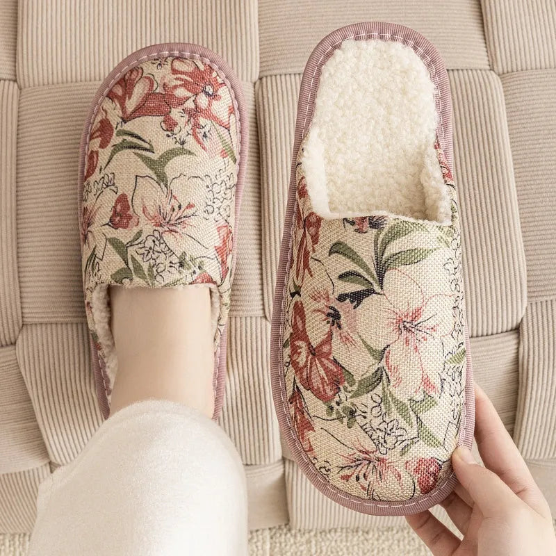 A pair of linen surface cotton lined slippers with a PVC sole, shown in a floral print colour option.