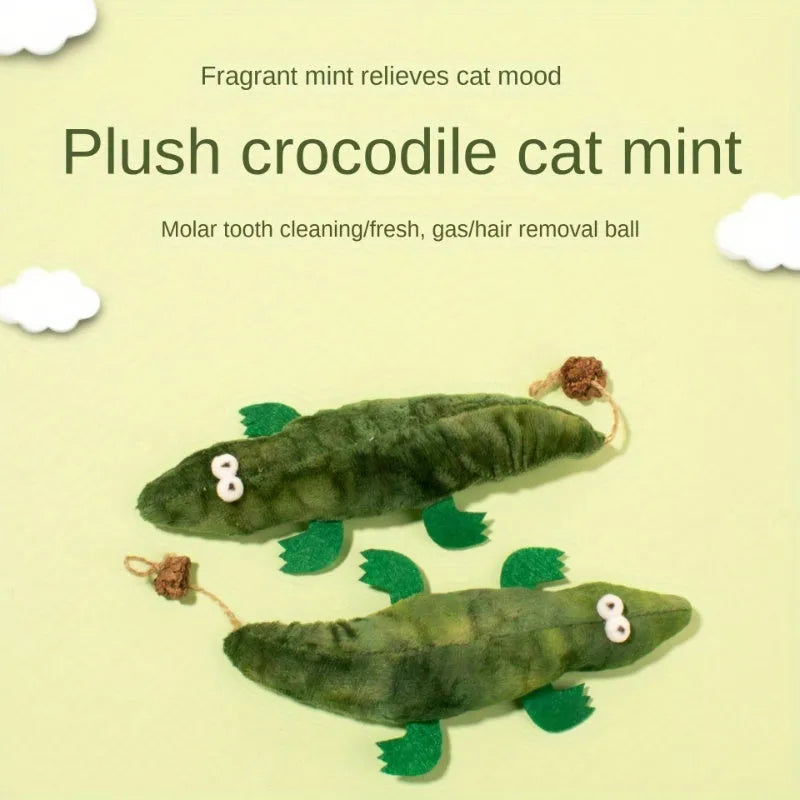 Green plush alligator catnip toy with peppermint scent on a white background.