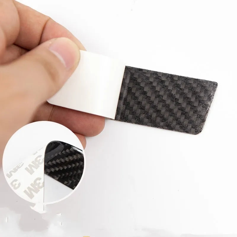 Carbon fibre door handle protective stickers for Tesla Model S, showing adhesive drip pattern.