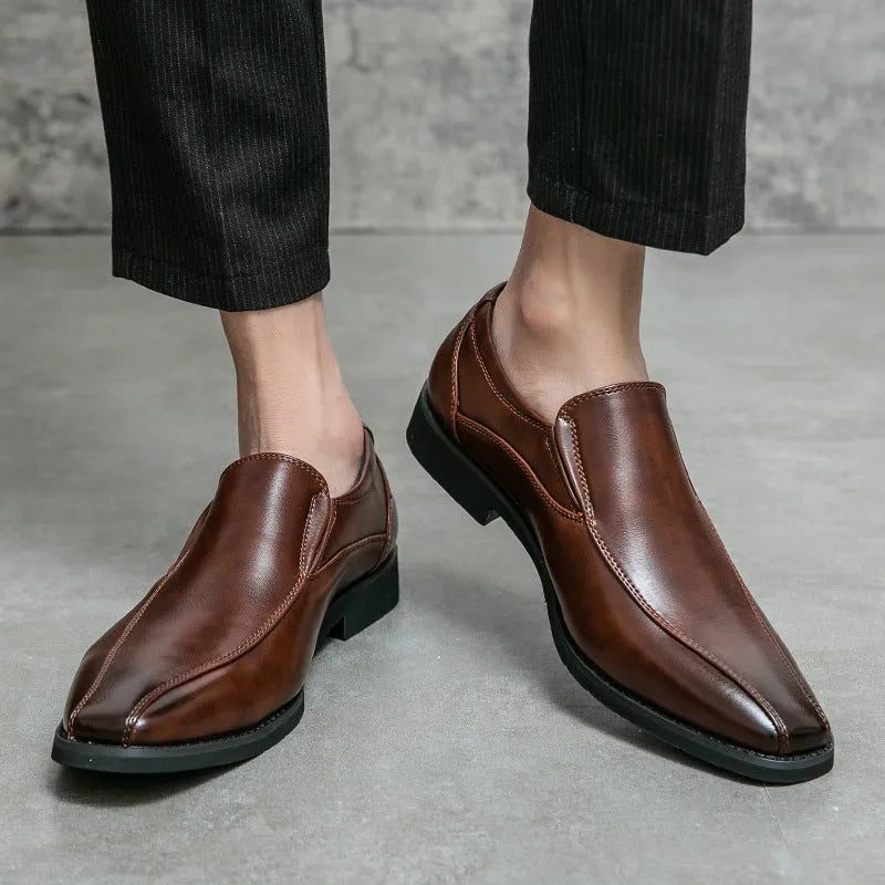 Men's black pointed casual shoes with a patent leather look and flat rubber sole.