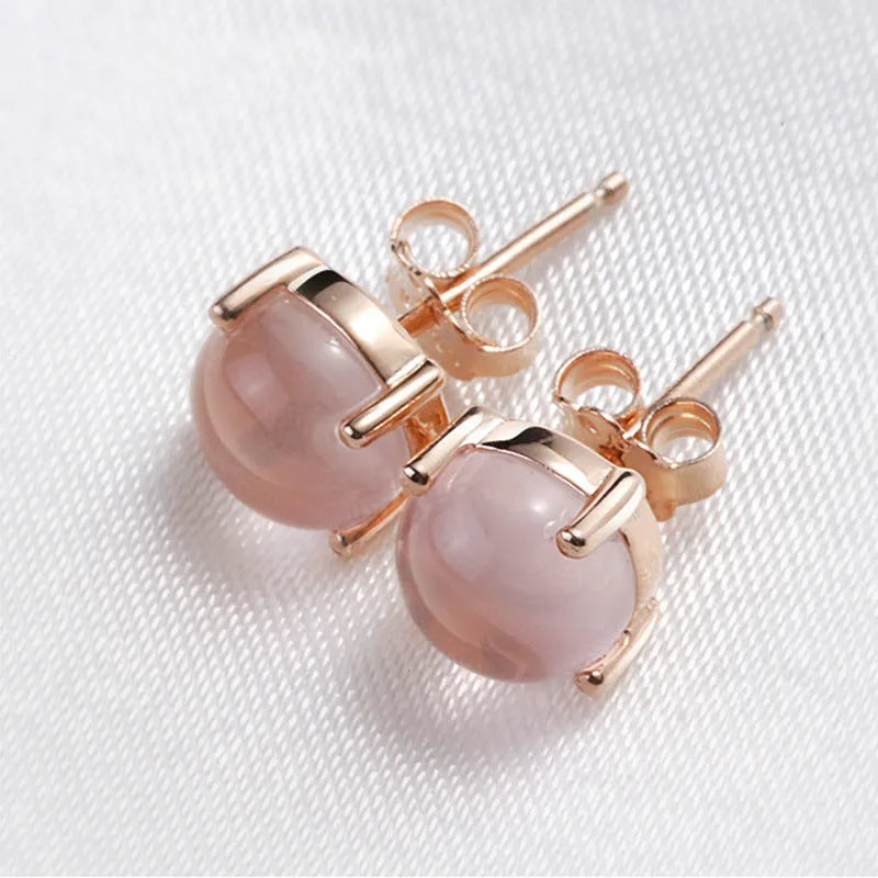 Rose gold drop shape stud earrings with synthetic ross quartz crystal inlay.