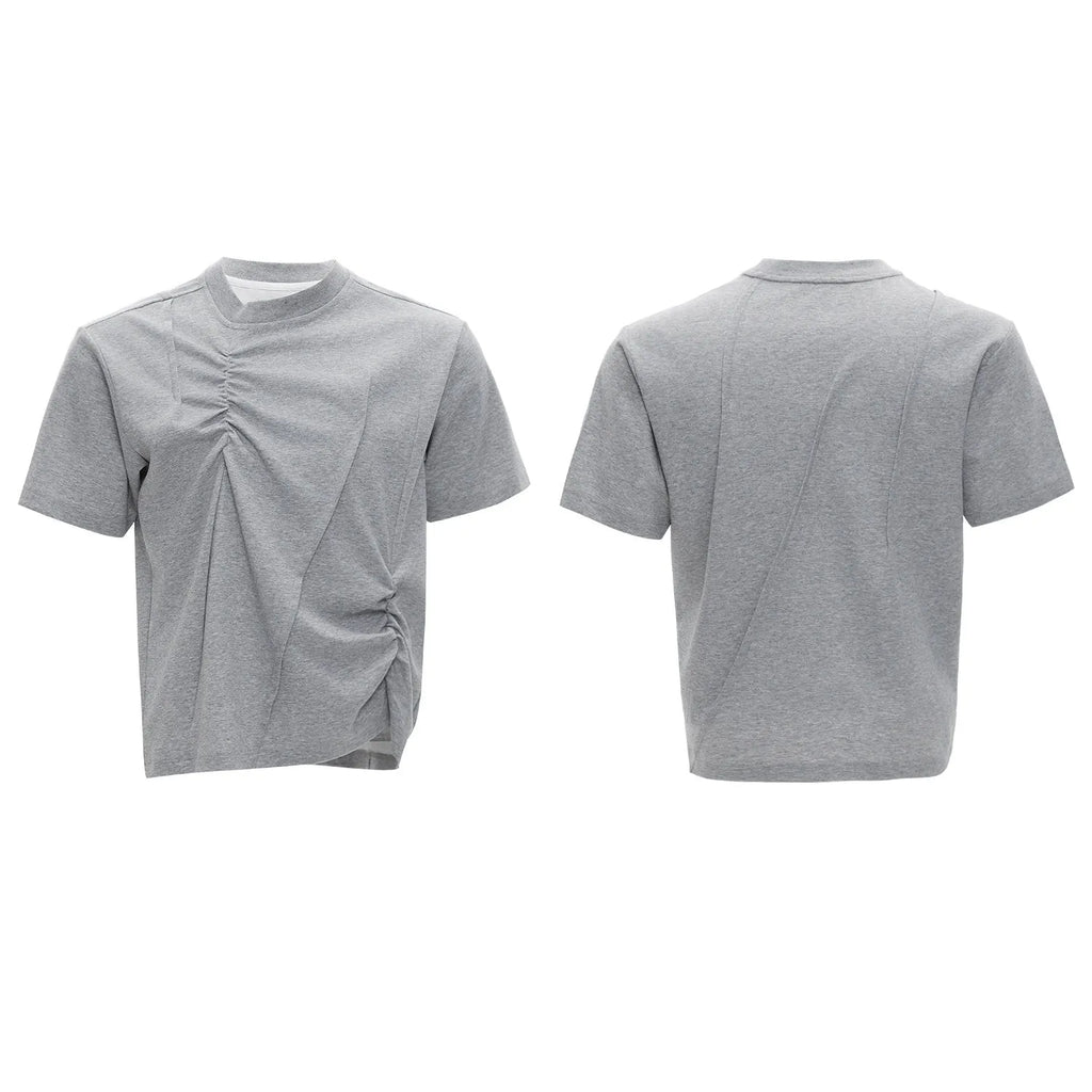 Man modelling a loose grey cotton T-shirt with a round neck and asymmetric stitching detail on the front.