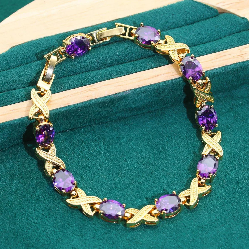 Gold-plated necklace, earrings, ring and bracelet set with blue cubic zirconia stones.