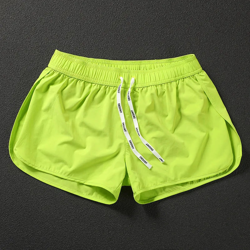 Men's loose fitting beach surfing trousers in polyester available in fluorescent green, orange red and black colours