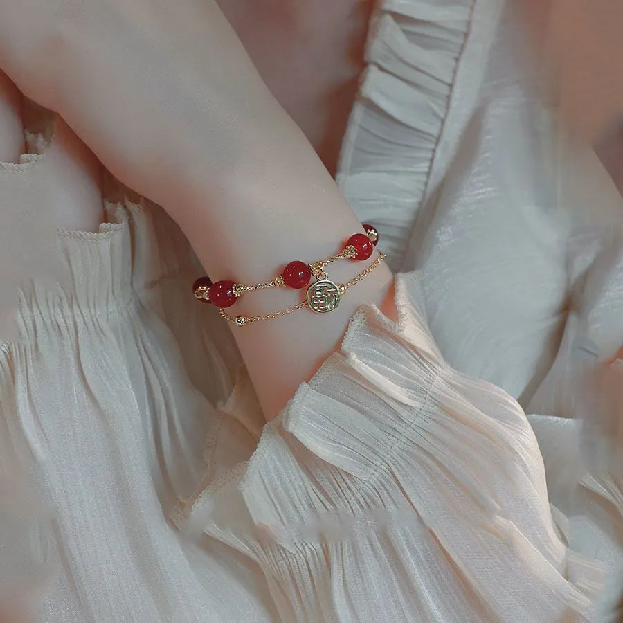 Red agate blessing card double-layer bracelet on display with alloy electroplated finish and chamfered square pattern