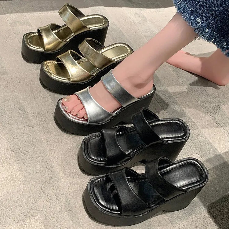 Women's black wedge platform slippers with square toe and PU upper.