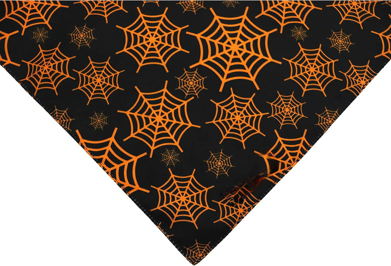 Black and orange reversible triangle dog bandana with Halloween pumpkin and spider web patterns.