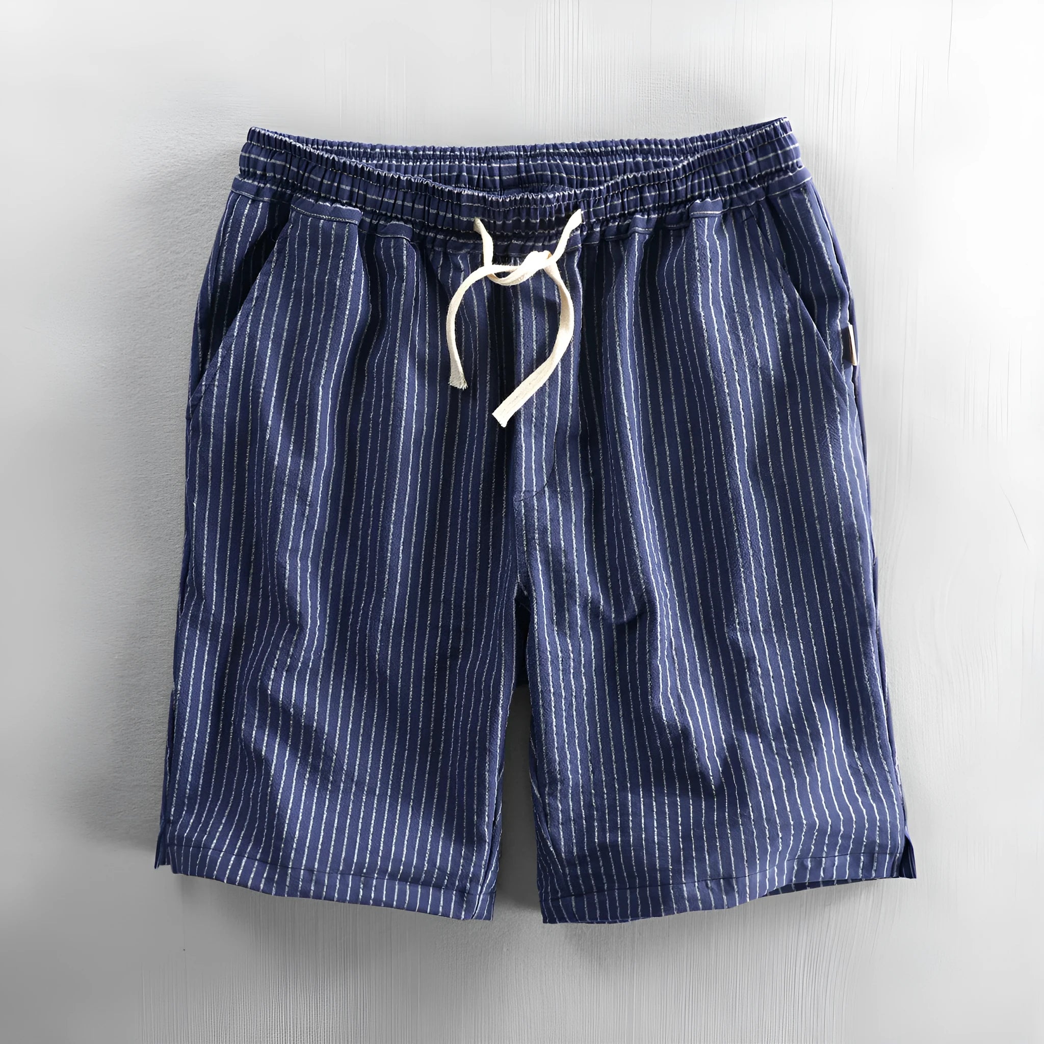 Men's striped cotton casual loose shorts on a hanger showing mid waist and shorts length.