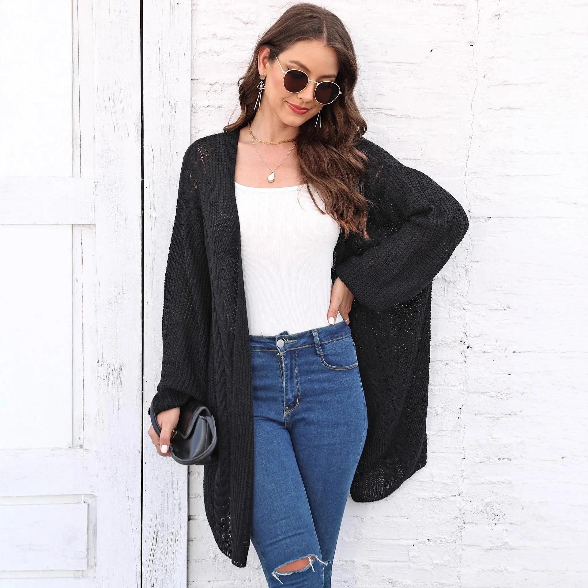 Women's loose acrylic sweater coat in army green, shown as a layering piece.
