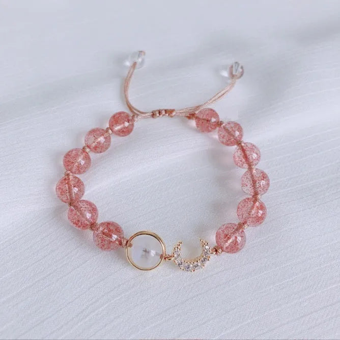 Handmade natural strawberry quartz crystal bracelet for women with moon and pearl bead designs.