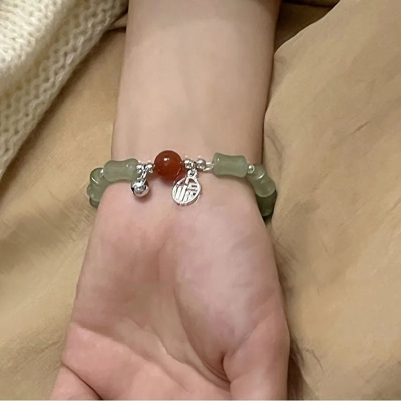 Handmade Chinese style glass bracelet with bamboo joint beads in a red Lvzhu Duobao design.