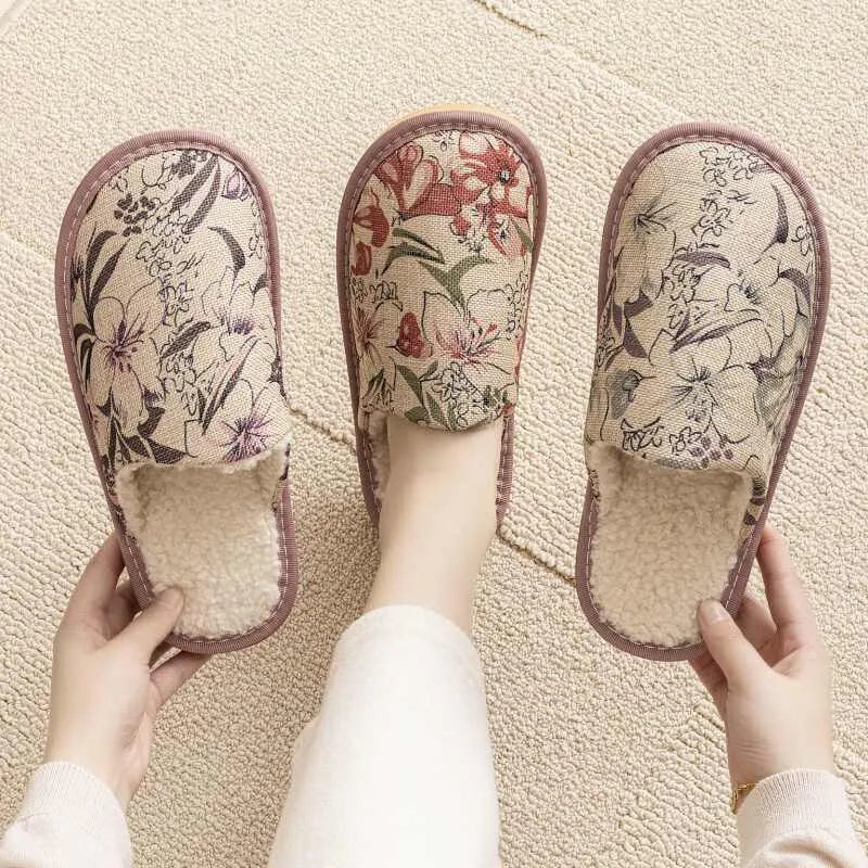 A pair of linen surface cotton lined slippers with a PVC sole, shown in a floral print colour option.