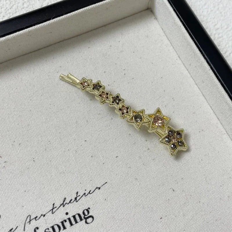 Gold-coloured Korean style hair clip barrette with side clip design and five-pointed star decoration