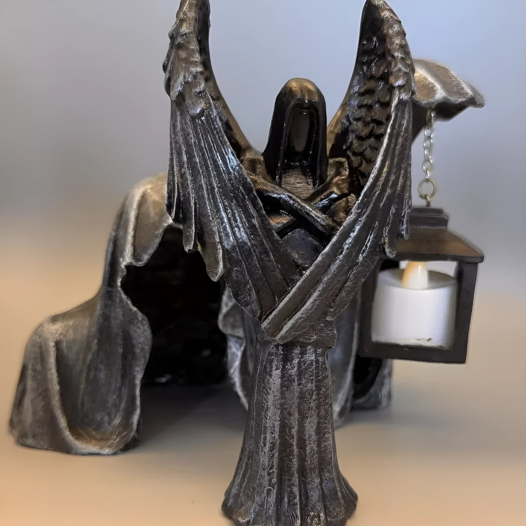 Dark angel resin statue ornament on a shelf, showing detailed sculptural form and dark colour finish.