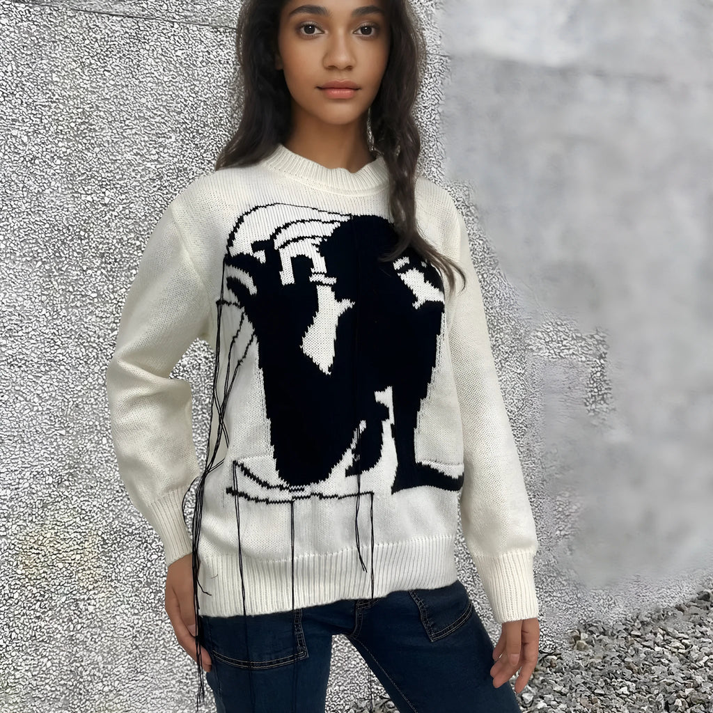 Grey alpaca wool women's sweater with abstract pattern and tassel detail on sleeve.