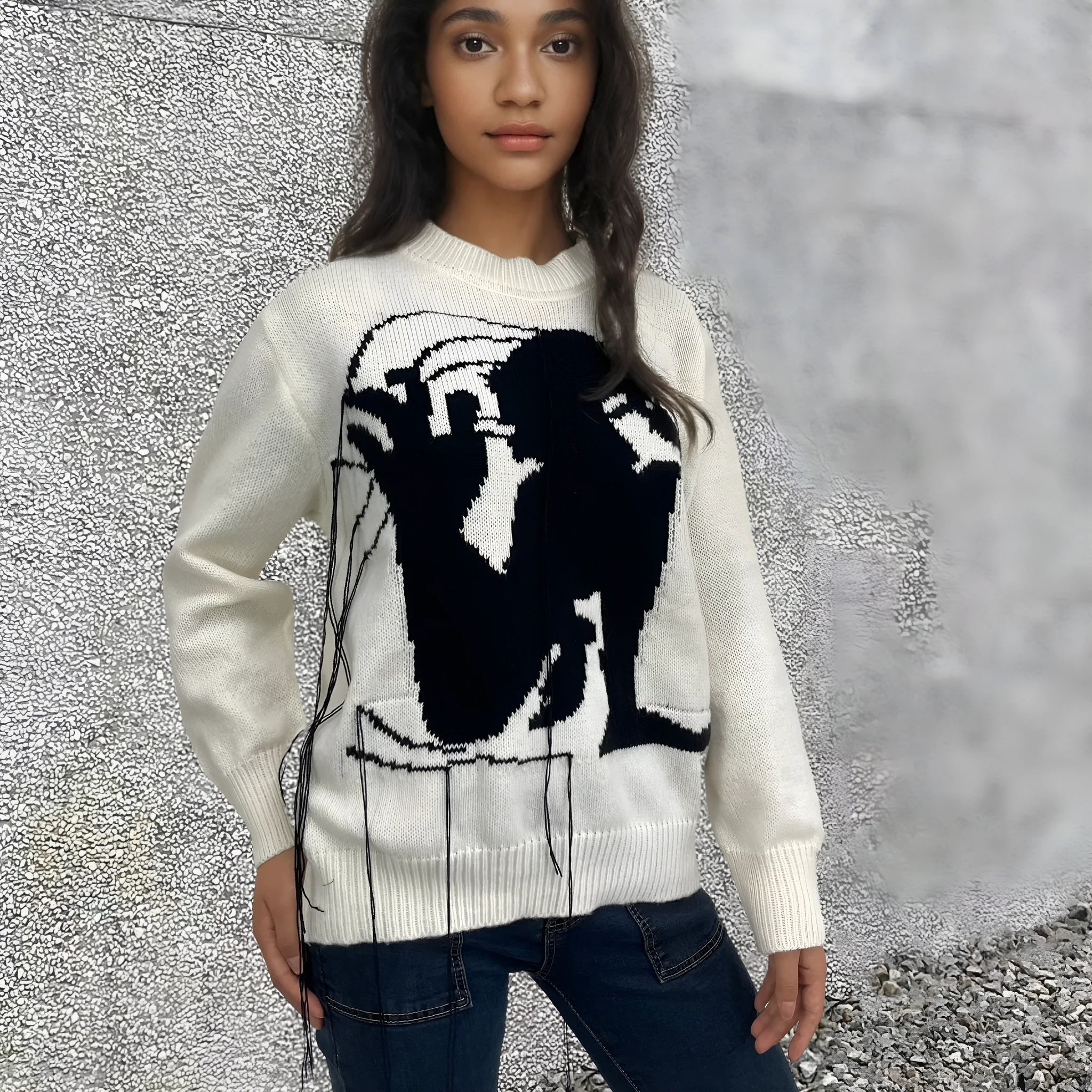 Grey alpaca wool women's sweater with abstract pattern and tassel detail on sleeve.