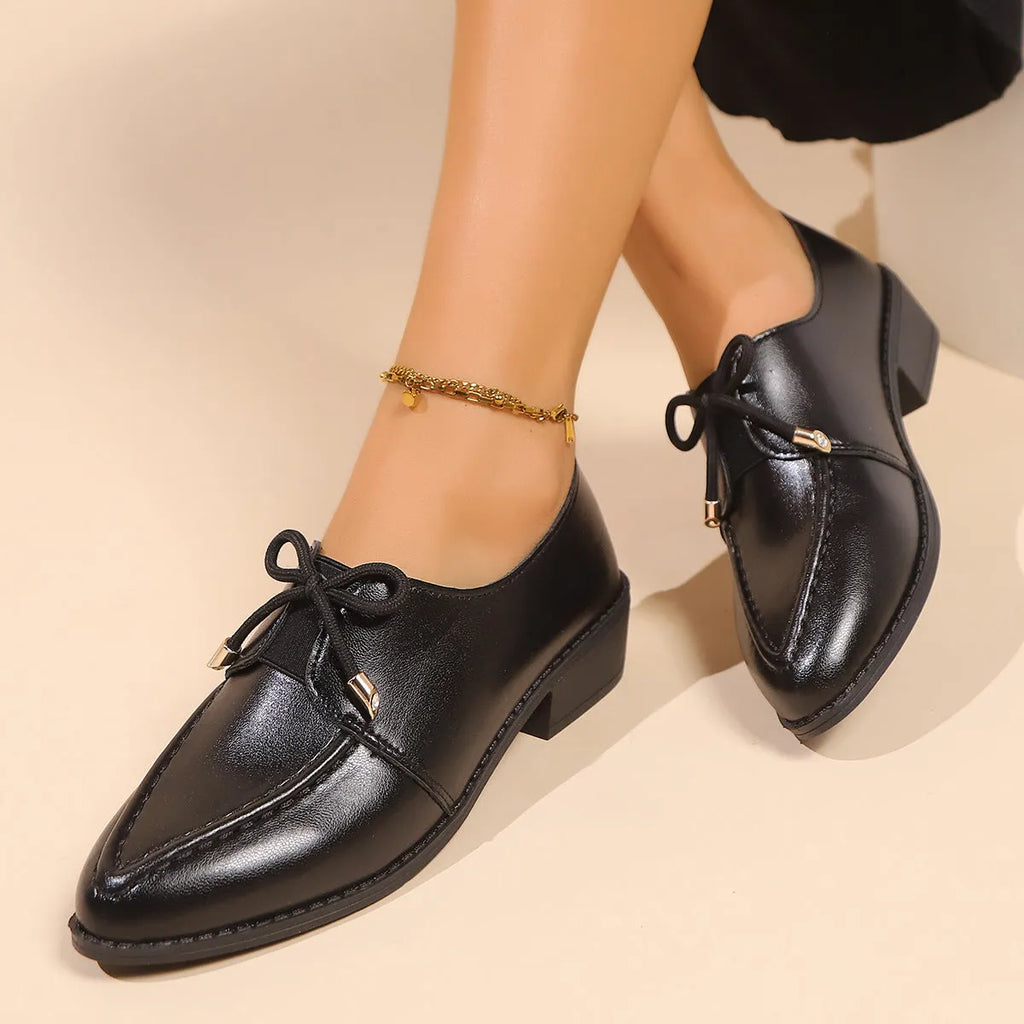 Women's British-style leather shoes with decorative bow detailing on pointed toe