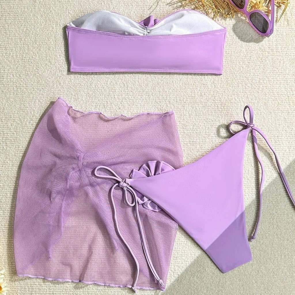 Women's pink tie-front tube top bikini set with large 3D flower and matching skirt.