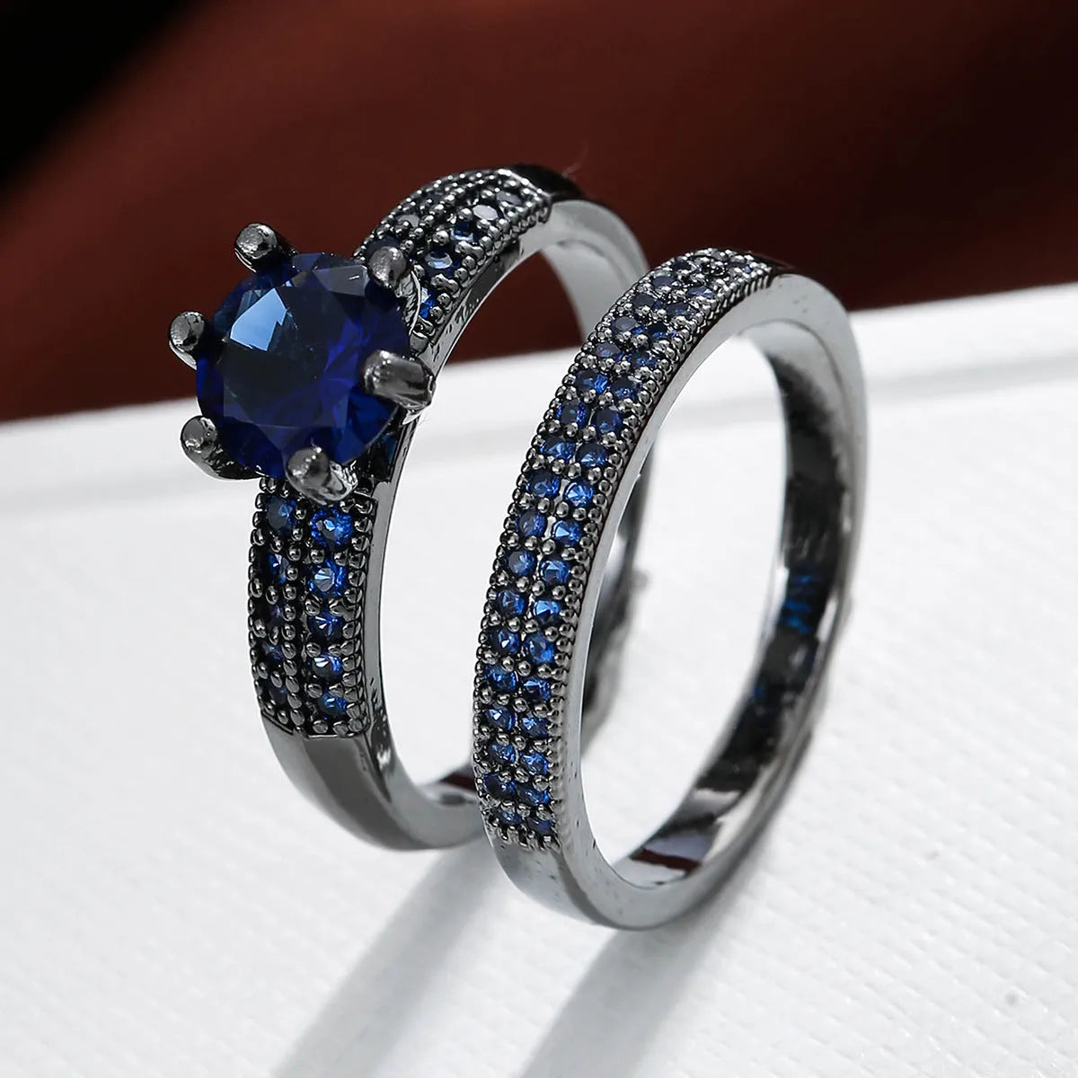Copper hollow geometric fashion ring with zircon accents in multiple colour finishes on a size chart