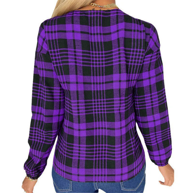 A woman wearing a loose-fitting purple plaid casual shirt with regular sleeves.