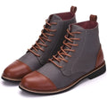 Men's black leather motorcycle boots with metal belt buckle details on a rubber sole.