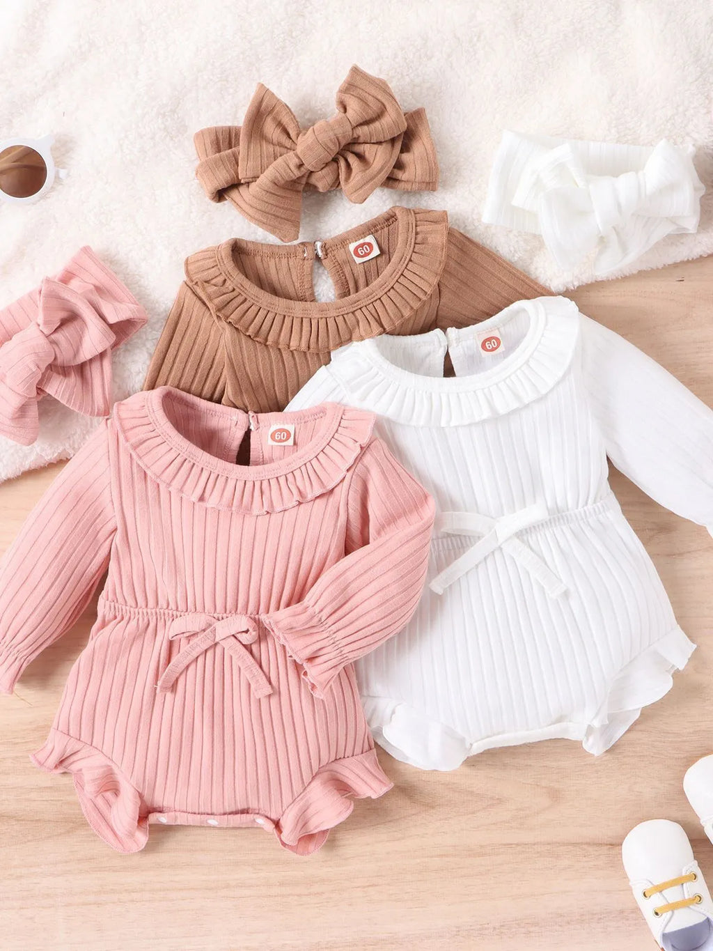 Baby girl wearing long sleeve cotton striped romper and headscarf in white