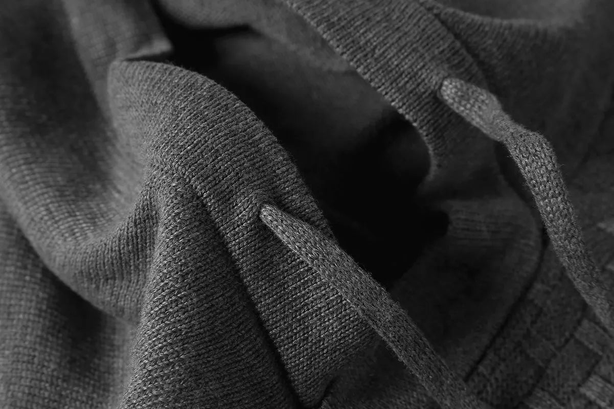 A man wearing a zip-up cotton blend hoodie in navy blue, showing the front kangaroo pocket and hood.