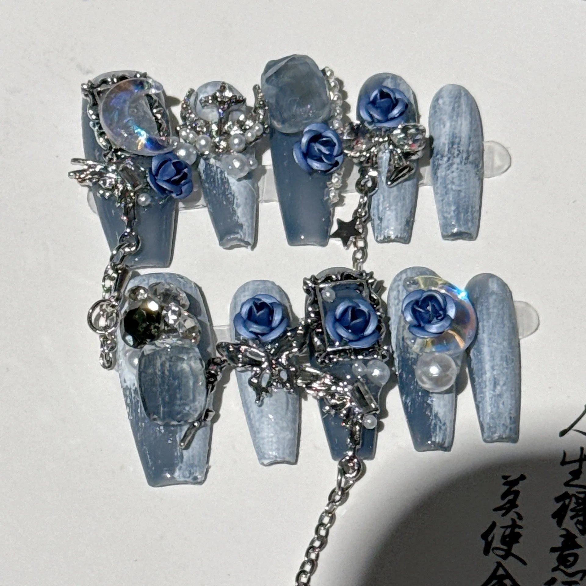 Heavy industry night blue manicure set with ornate rose design and plastic storage case.