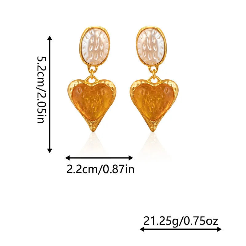 A pair of oval-shaped, pleated love heart stud earrings in alloy, shown in various colours.