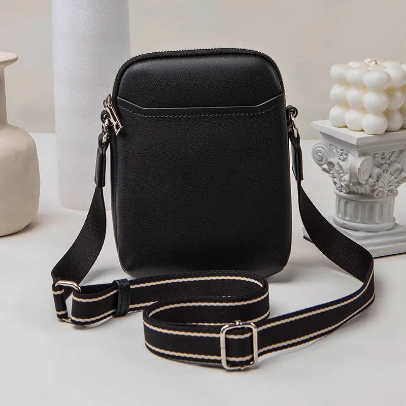Solid colour small crossbody shoulder bag in PU leather measuring 14.5cm by 5.5cm by 19cm