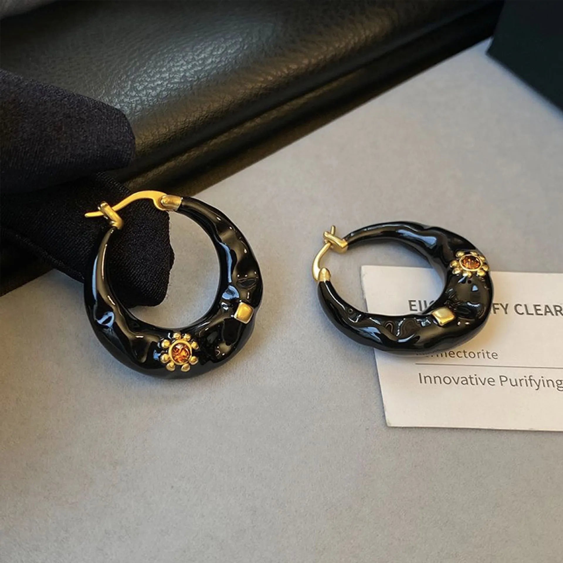 Hong Kong style retro ear studs with dripping oil finish and rhinestone detail in black and red colours