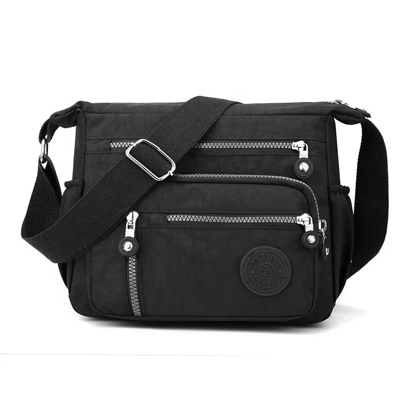 Soft nylon messenger shoulder bag in a choice of five colours including black and blue.