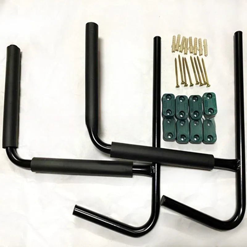 Black carbon steel kayak and surfboard wall hanger storage rack mounted on a wall.