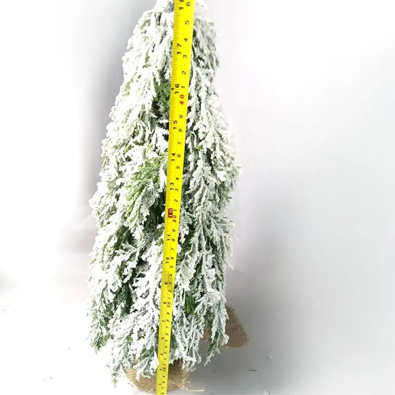 24 inch plastic Christmas tree with lights and PE snow decoration on desktop