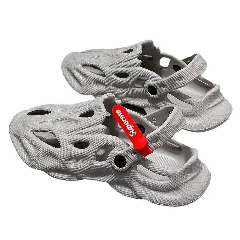 Pair of gray closed-toe EVA coconut slippers with a textured frosted finish and perforated upper.