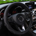 Black embossed corrugated elastic steering wheel cover shown fitted on a car steering wheel.